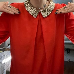 Orange shirt with a sequinned collar